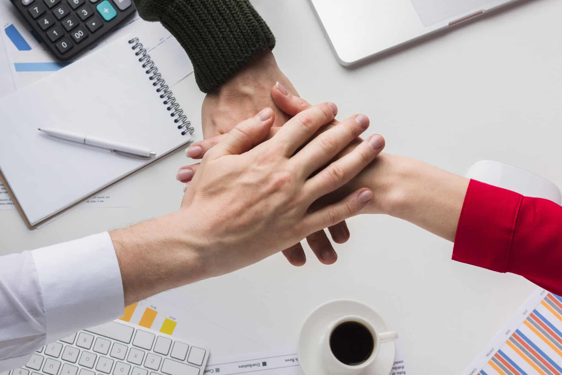 top-view-hands-together-desk